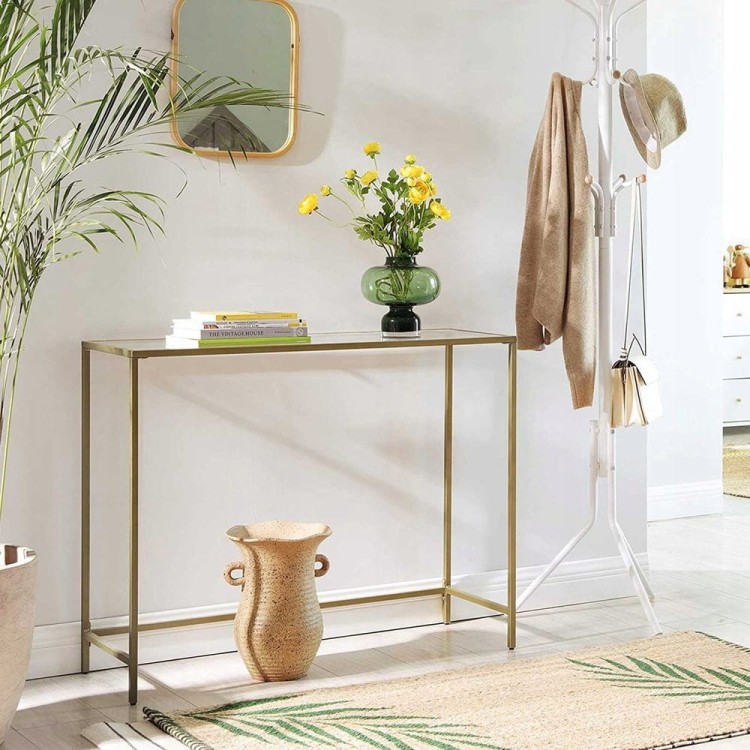 Konsola GLAMOUR z połyskującą złotą ramą i hartowanym szkłem – elegancki i funkcjonalny element wyposażenia nowoczesnego salonu.